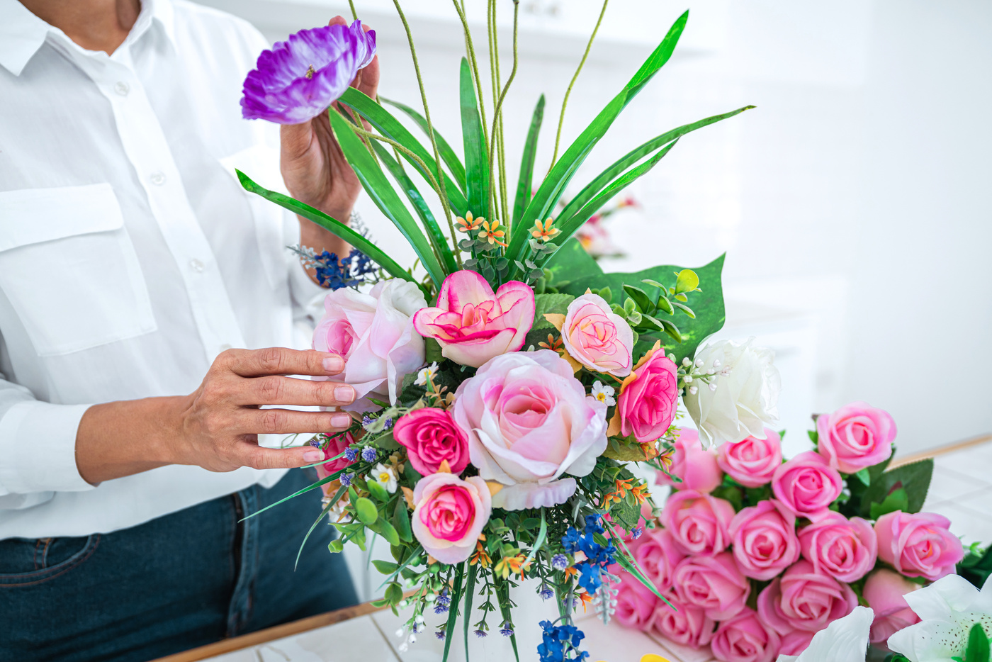 Woman Arranging Artificial Flowers 